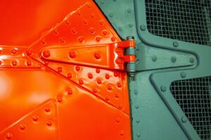 Metal machinery with a two-tone orange and green design.